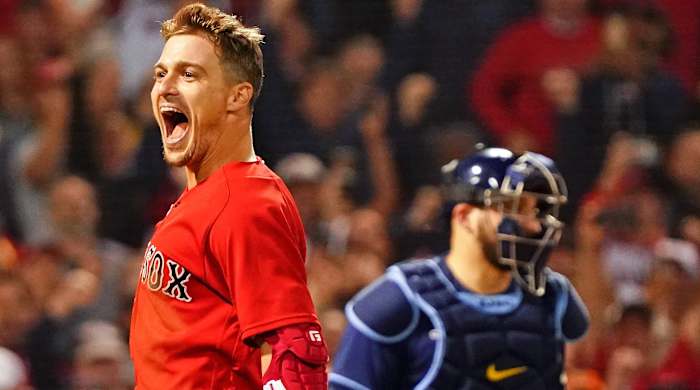 Boston Red Sox center fielder Enrique Hernandez (5) reacts after hitting a walk-off sacrifice fly against the Tampa Bay Rays to score pinch runner Danny Santana (22) during the ninth inning